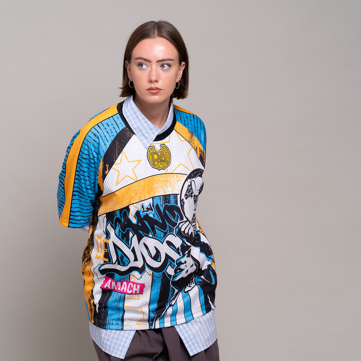 AMACH Rebel Athletics Maradona jersey, blue, white and yellow 90s-style football shirt, front close-up