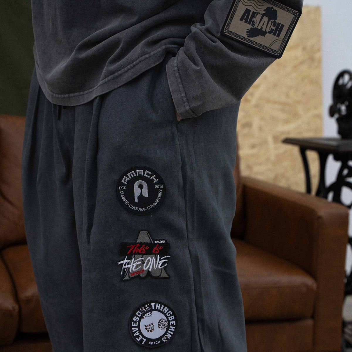 Close-up of embroidered patches on AMACH By Any Means patch trousers
