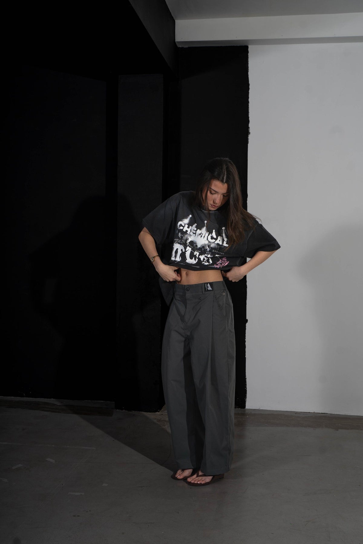 Model holding out the AMACH Chemical Dust t-shirt to show the graphic
