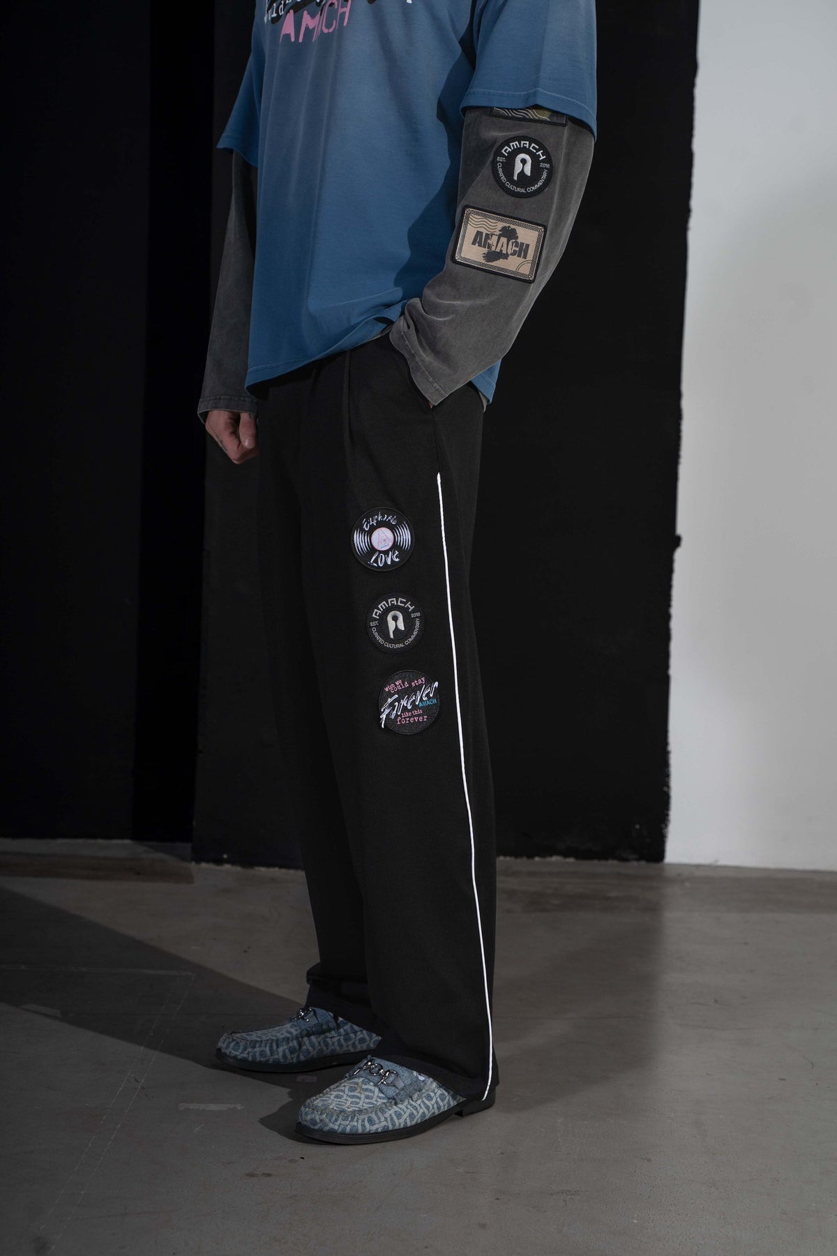 AMACH Euphoric Love slacks with white side stripe, worn with a blue tee