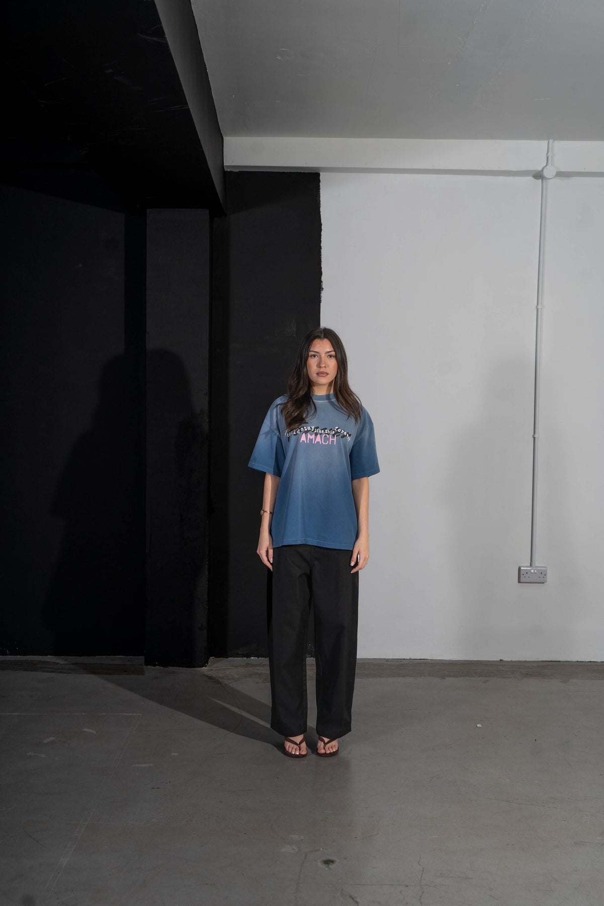 Model wearing the AMACH Wish We Could Stay Like This Forever t-shirt in sun-faded blue